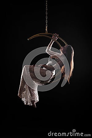 The girl, an aerial acrobat, performs on a sports equipment of the Stock Photo