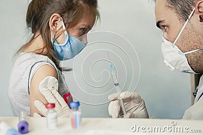 Girl afraid of injections at the doctor`s office. girl is experiencing pain and fear from the vaccination. injection in the Stock Photo