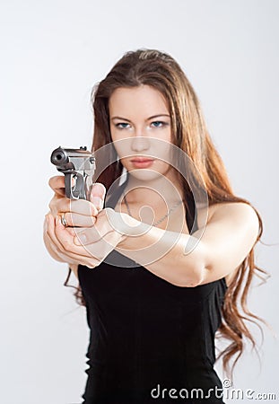 Girl aiming a gun Stock Photo