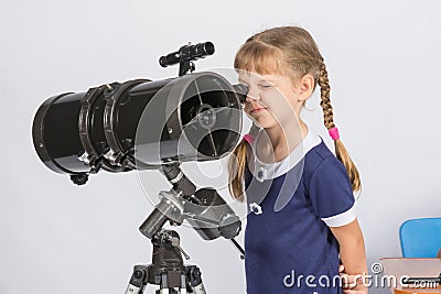 Girl amateur astronomer watching stars through a telescope Stock Photo