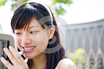 Girl apply lipstick Stock Photo