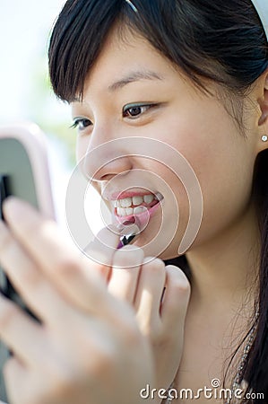 Girl apply lipstick Stock Photo