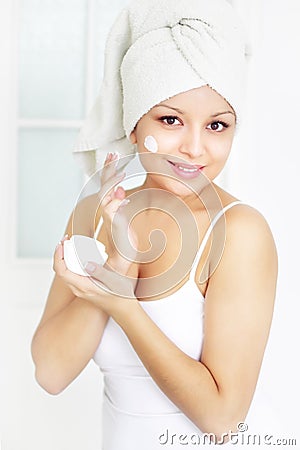 Girl applying cream on skin Stock Photo