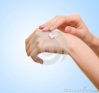 Girl applying some white lotion on her hand Stock Photo