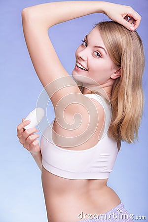 Girl applying stick deodorant in armpit. Skin care Stock Photo