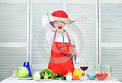 Girl in apron whipping eggs or cream. Start slowly whisking or beating cream. Confectionery and patisserie. Whipping Stock Photo