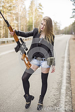 Girl assassin waiting for his victim on the road. Stock Photo