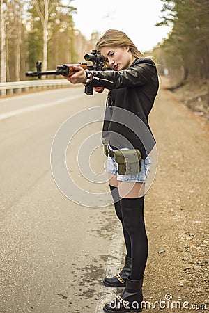 Girl assassin waiting for his victim on the road. Stock Photo