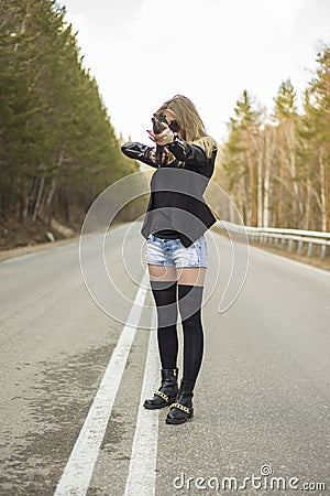 Girl assassin waiting for his victim on the road. Stock Photo