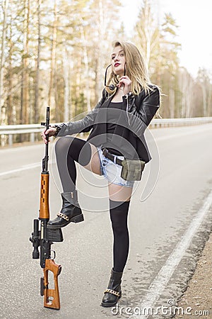 Girl assassin waiting for his victim on the road. Stock Photo