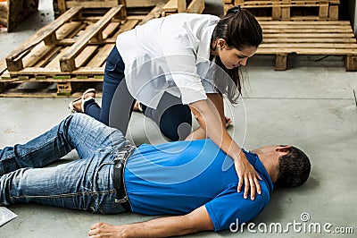 Girl assisting an unconscious man Stock Photo