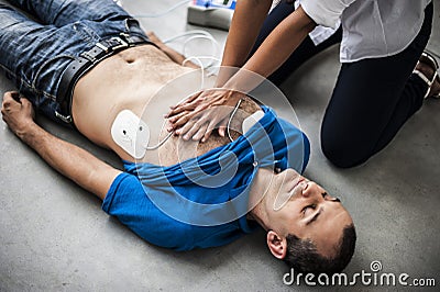 Girl assisting an unconscious man Stock Photo