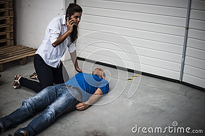 Girl assisting an unconscious man Stock Photo