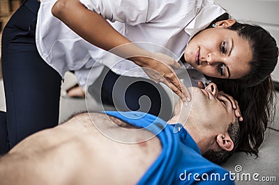 Girl assisting an unconscious man Stock Photo