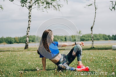 Girl athlete does squats in nature exercises for the buttocks. Young woman go in for sports healthy lifestyle athletic body. Stock Photo