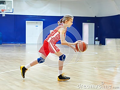 Girl athlete in uniform playing basketball Stock Photo