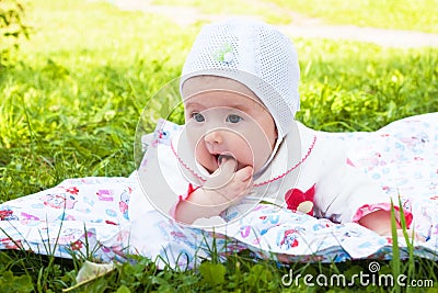 Girl baby a rattle played outdoors Stock Photo