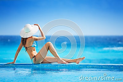 Girl from back with white hat in striped bikini Stock Photo