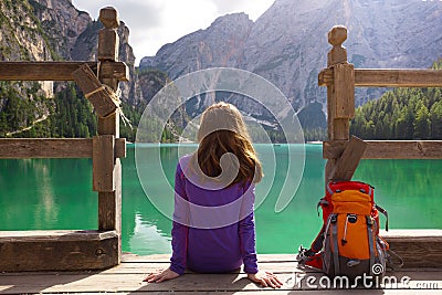 Girl backpacker looking at Braies lake Stock Photo