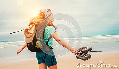 Girl backpacker traveler enjoys with fresh ocean wind Stock Photo