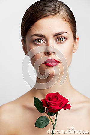 Girl with bare shoulders model holding a rose bright makeup Stock Photo