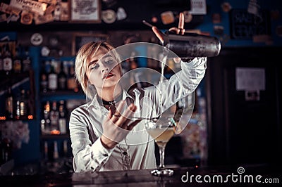 Girl barman makes a cocktail on the saloon Stock Photo