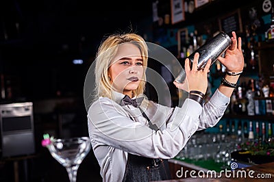 Girl barman mixes a cocktail in the beerhouse Stock Photo