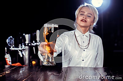 Girl bartender makes a cocktail at the beerhall Stock Photo