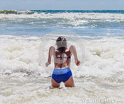 Girl bathing in the sea with a big wave. Resort Albena Editorial Stock Photo