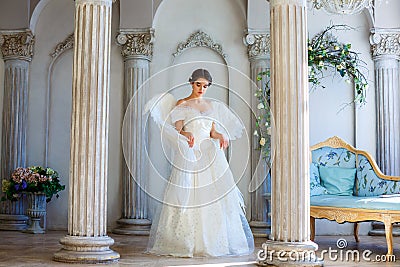 A girl in a beautiful dress and white wings of an angel inspires Stock Photo