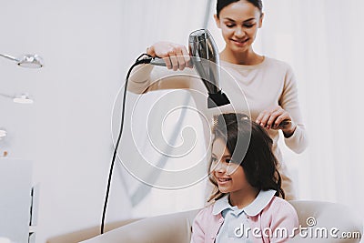 Hairdresser Dries Hair Blow Dryer Beautiful Girl. Stock Photo