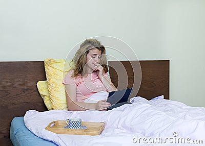 girl from the bed with the gadget , the young girl thought, coffee Stock Photo