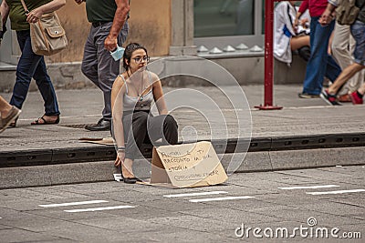 Girl begs on the sidewalk Editorial Stock Photo
