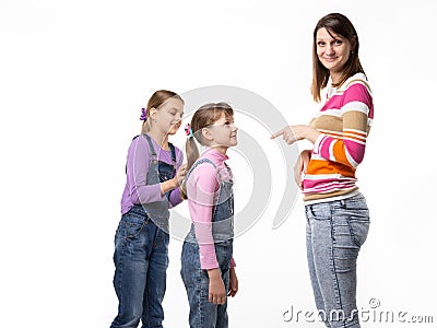 The girl begs the toy from her mother, mother wearily points a finger at the child Stock Photo