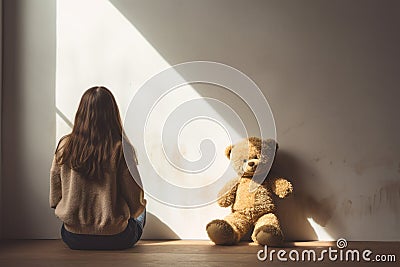 girl behind body with teddy bear sitting and facing an empty white wall in classroom. AI Generated Stock Photo