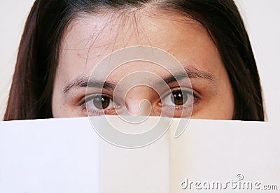 Girl behind book Stock Photo