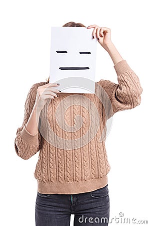 Girl covers her face with a smiley face sheet with a poker face on a white background Stock Photo