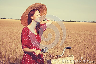 Girl with bicycle on field. Stock Photo