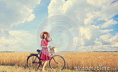 Girl with bicycle on field. Stock Photo