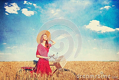 Girl with bicycle on field. Stock Photo
