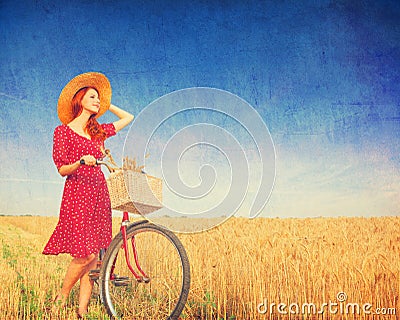 Girl with bicycle on field. Stock Photo