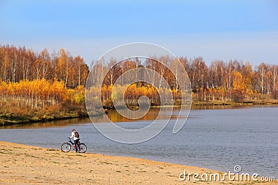 Girl with Bike on Lakeside Stock Photo