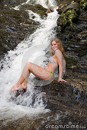 Girl in a bikini on rocks at a Mingo Falls. Stock Photo