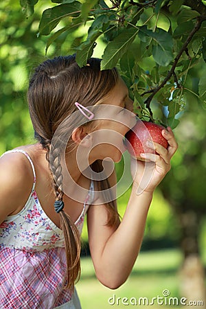 Girl biting into an apple Stock Photo