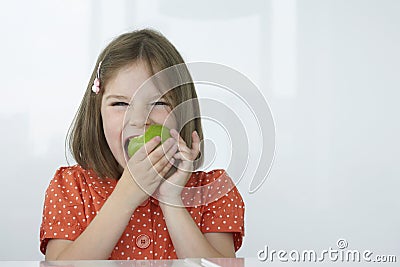 Girl Biting Green Apple Stock Photo