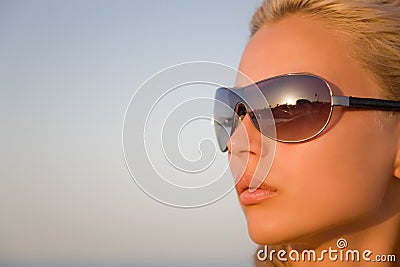 Girl with black glasses isolated on a blue sky Stock Photo