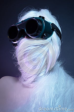 Girl in black glasses with long white hair wrapped around her head Stock Photo