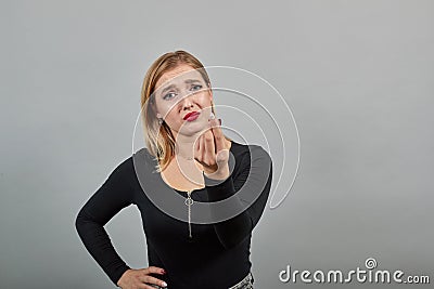 Girl in black jacket compassionate woman asks for help, gestures with hands Stock Photo