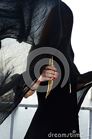 Girl in black with an oriental dagger Stock Photo