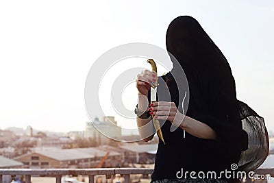 Girl in black with an oriental dagger Stock Photo